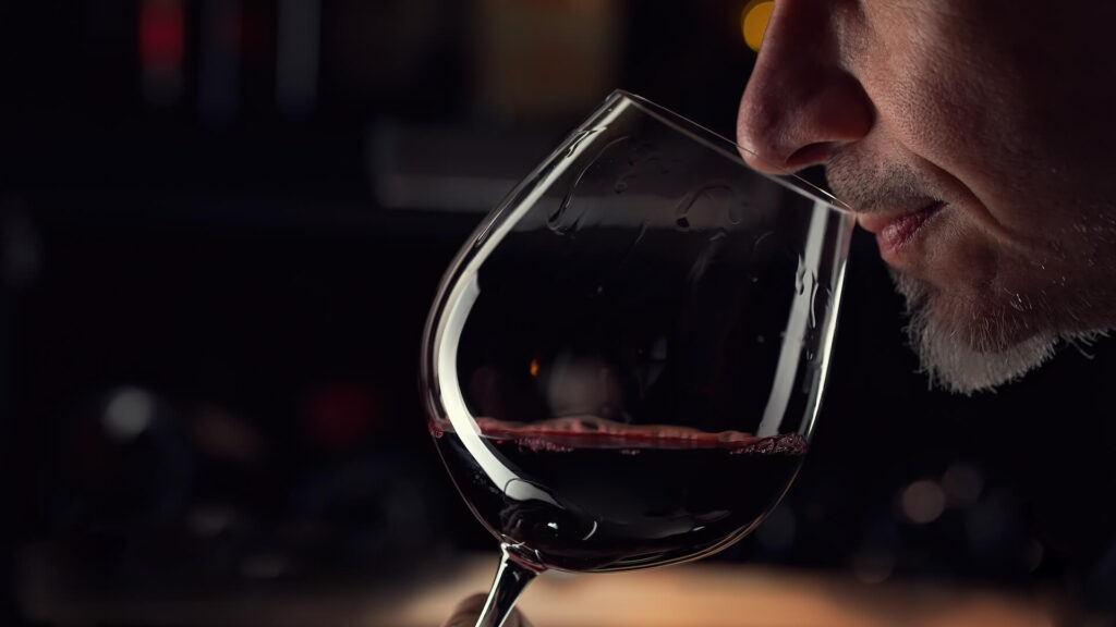 picture of a man smelling-wine